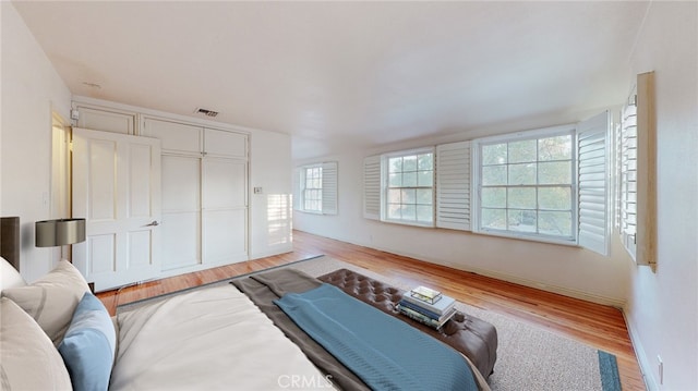 bedroom with a closet and light wood-type flooring