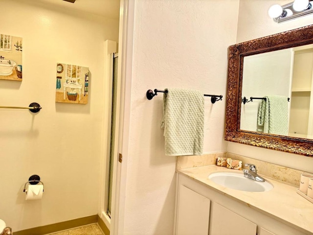 bathroom featuring vanity, walk in shower, and tile patterned floors