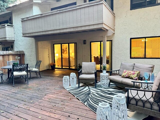 wooden deck with an outdoor living space