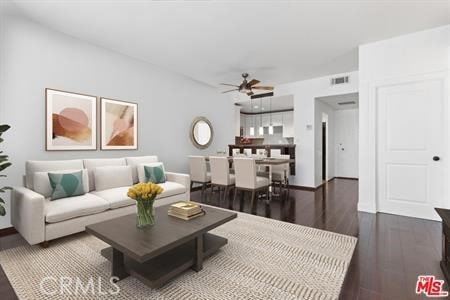 living room with dark hardwood / wood-style flooring and ceiling fan