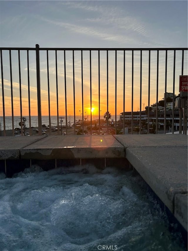 exterior space featuring a jacuzzi and a water view