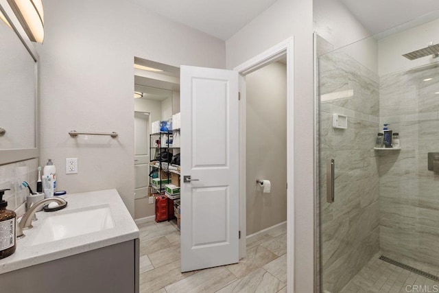 bathroom featuring vanity and a shower with door