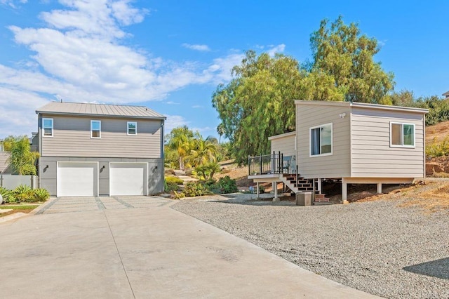 exterior space featuring a wooden deck and a garage