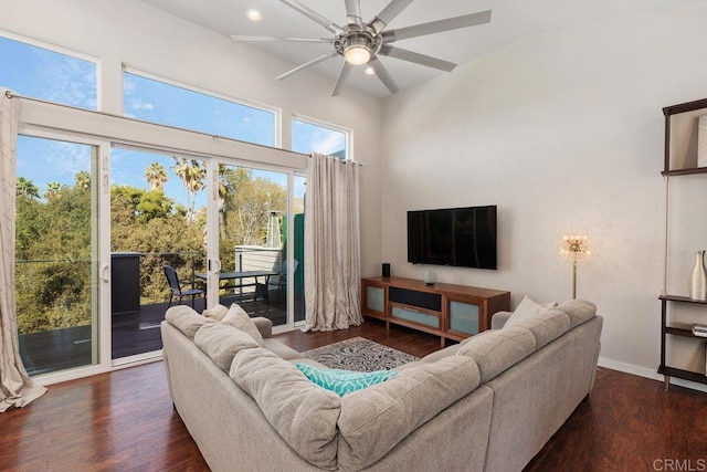 living room featuring ceiling fan and dark hardwood / wood-style floors