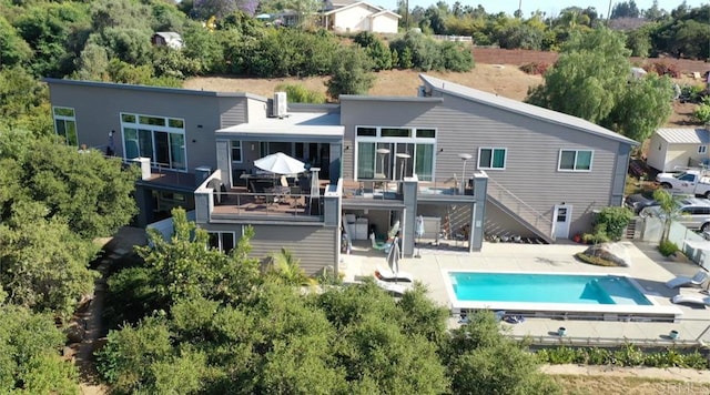 rear view of property with a patio area and a pool side deck