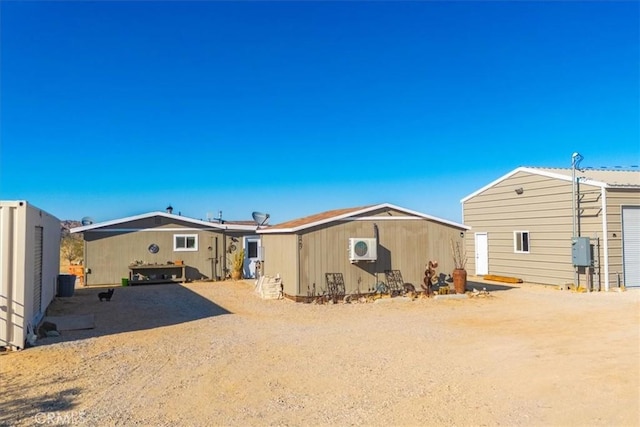 rear view of property featuring ac unit