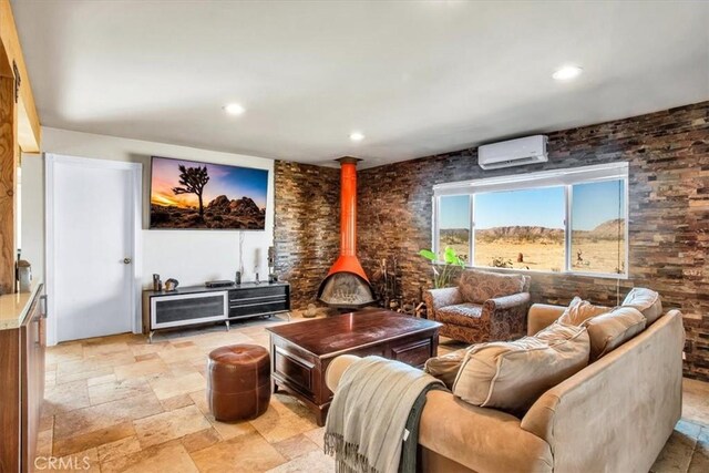 living room featuring an AC wall unit and a wood stove