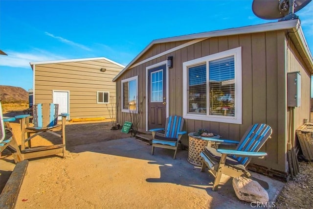 rear view of property featuring a patio