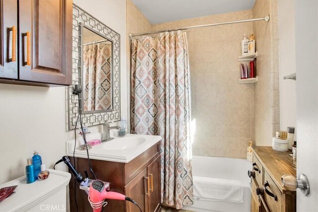 full bathroom featuring shower / bath combo, vanity, and toilet