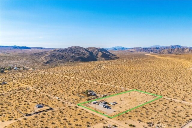 birds eye view of property with a mountain view