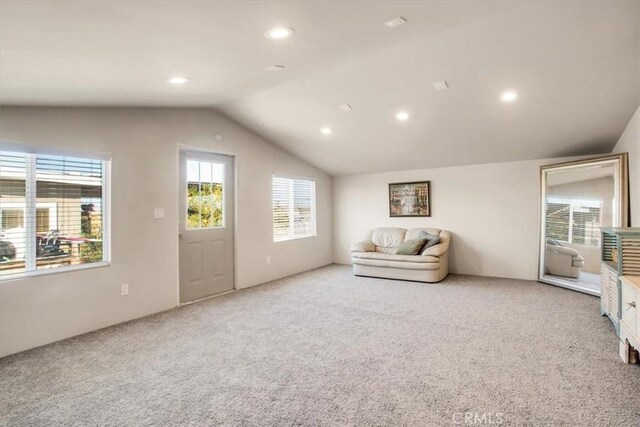 unfurnished room featuring carpet flooring and lofted ceiling