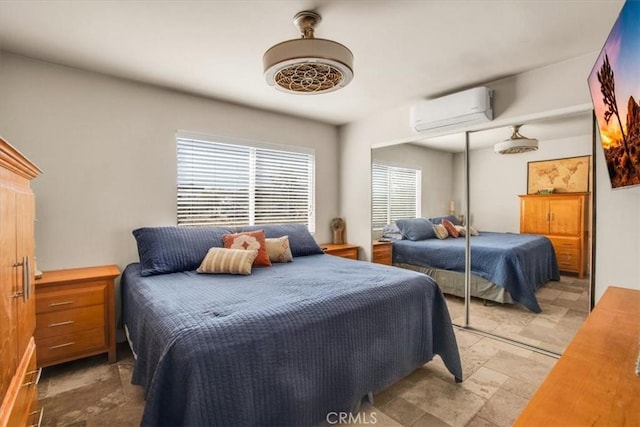 bedroom featuring a wall unit AC and a closet