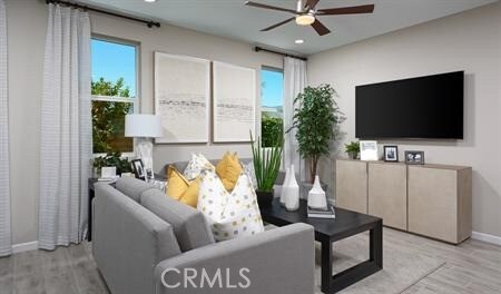 living room with light hardwood / wood-style floors and ceiling fan