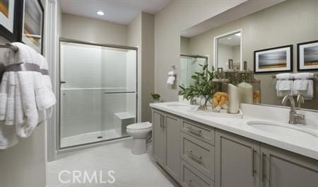 bathroom with vanity, toilet, and an enclosed shower