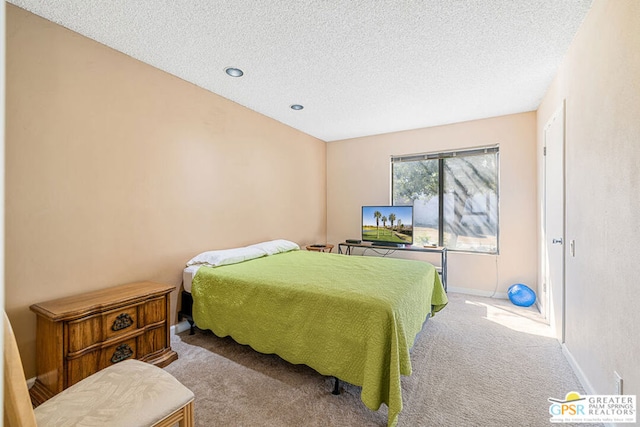 carpeted bedroom featuring a textured ceiling