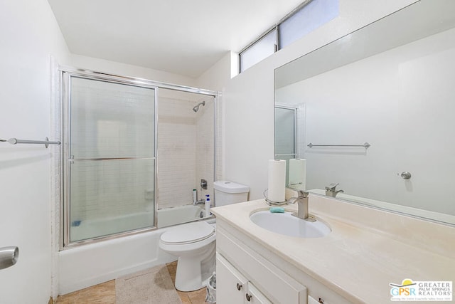 full bathroom with vanity, tile patterned floors, toilet, and combined bath / shower with glass door