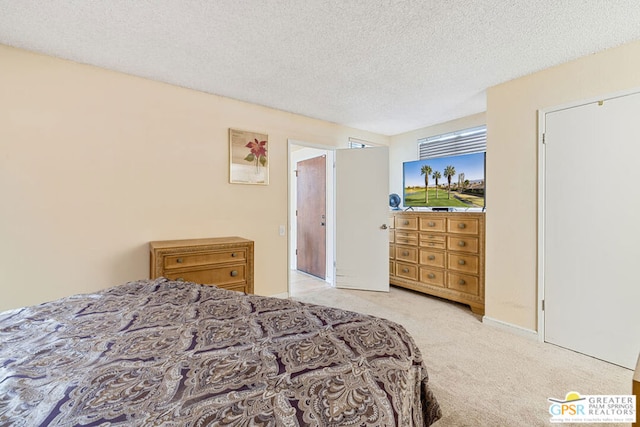 carpeted bedroom with a textured ceiling