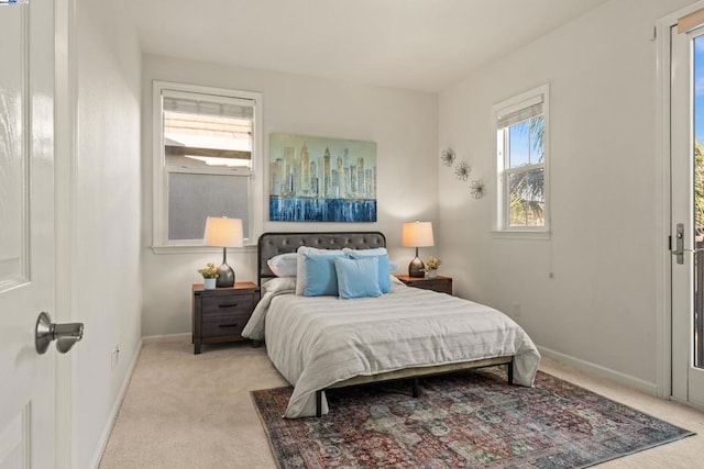 carpeted bedroom featuring multiple windows