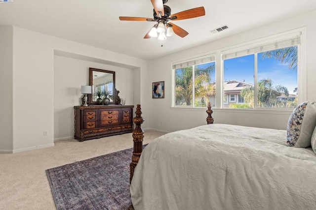 bedroom with ceiling fan and light colored carpet