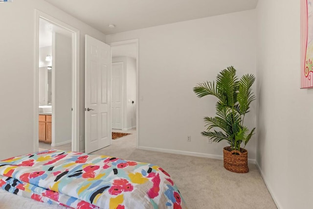 carpeted bedroom with connected bathroom