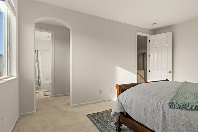 carpeted bedroom featuring ensuite bathroom