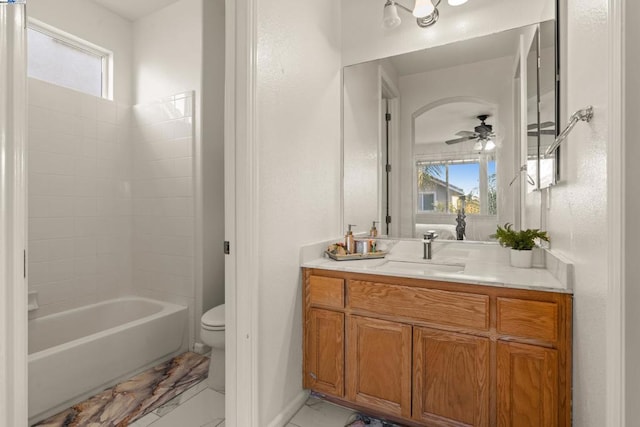 full bathroom featuring a wealth of natural light, ceiling fan, vanity, and toilet