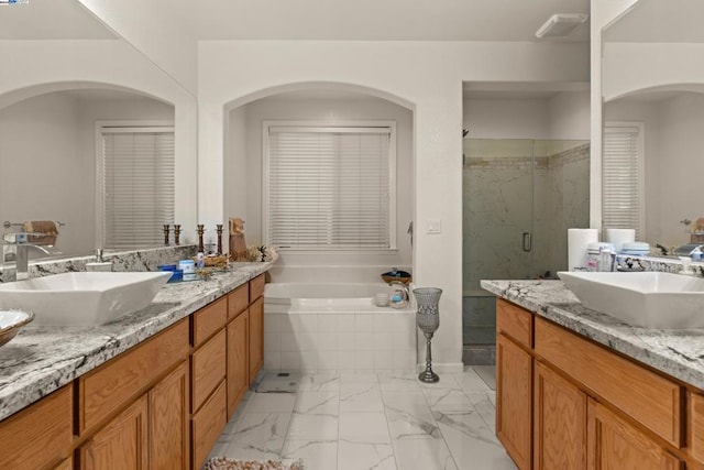 bathroom featuring independent shower and bath and vanity