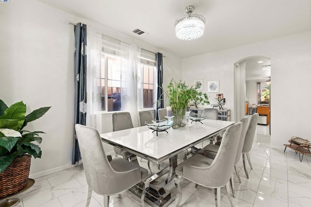 dining space featuring an inviting chandelier