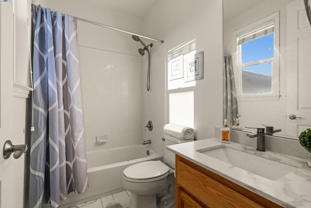 full bathroom featuring shower / tub combo with curtain, vanity, and toilet