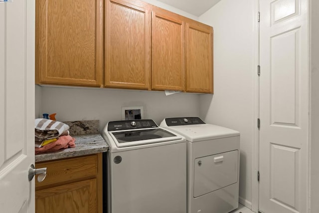 laundry room with cabinets and independent washer and dryer