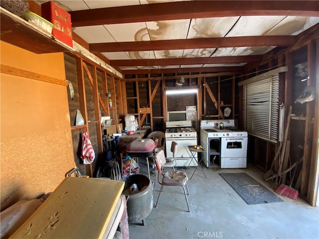 miscellaneous room with beam ceiling, concrete flooring, and washer / clothes dryer