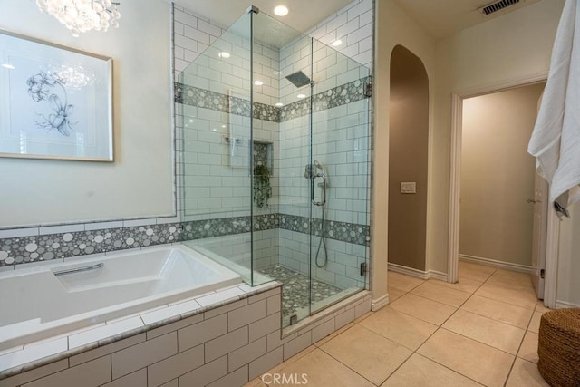 bathroom with shower with separate bathtub and tile patterned floors