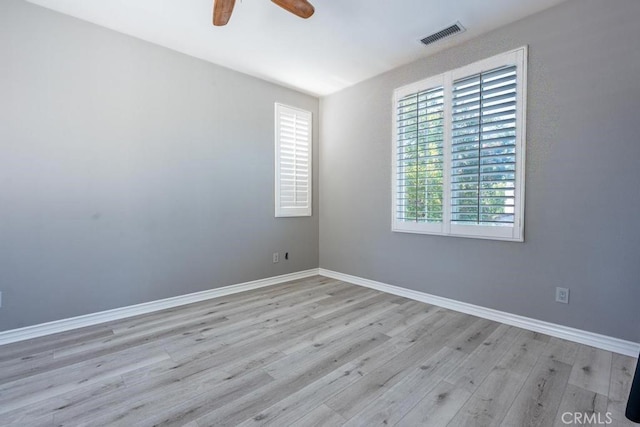 empty room featuring ceiling fan and light hardwood / wood-style flooring