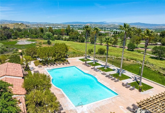 view of pool featuring a mountain view and a patio