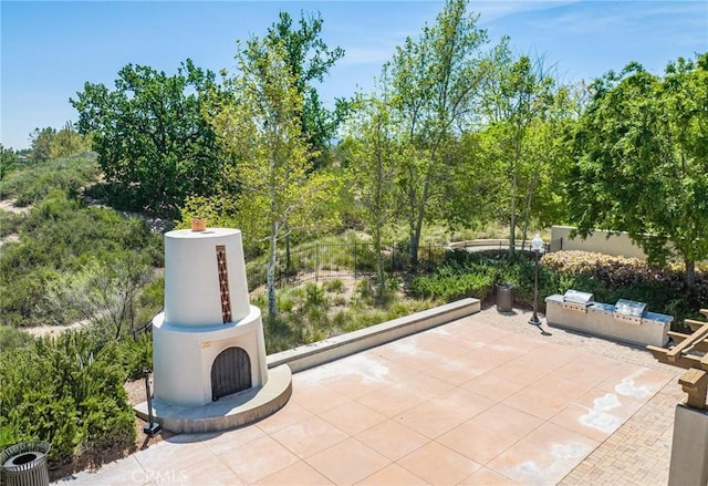 view of patio / terrace featuring an outdoor fireplace