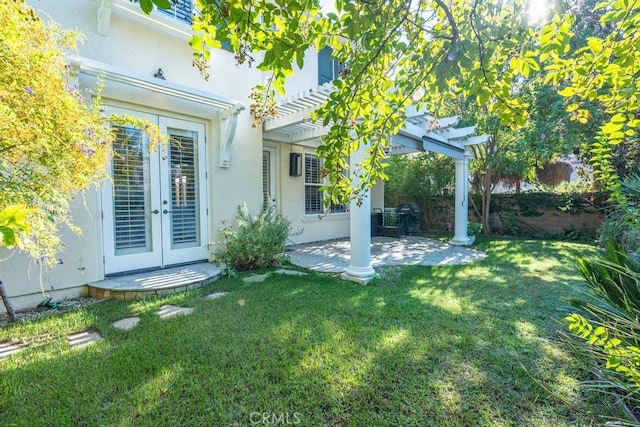 view of yard with french doors, a pergola, and a patio