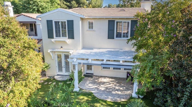 back of house with french doors and a patio