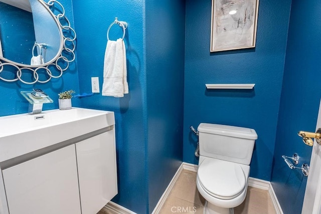 bathroom with tile patterned floors, vanity, and toilet