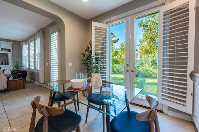 tiled dining space featuring french doors