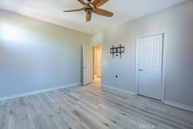 unfurnished bedroom featuring ceiling fan and light hardwood / wood-style floors