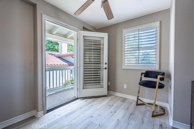 doorway to outside with ceiling fan and light hardwood / wood-style flooring