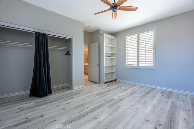 unfurnished bedroom with light wood-type flooring, a closet, and ceiling fan