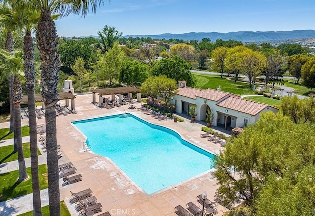 view of pool featuring a mountain view and a patio