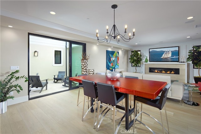 dining area featuring light hardwood / wood-style flooring and a notable chandelier