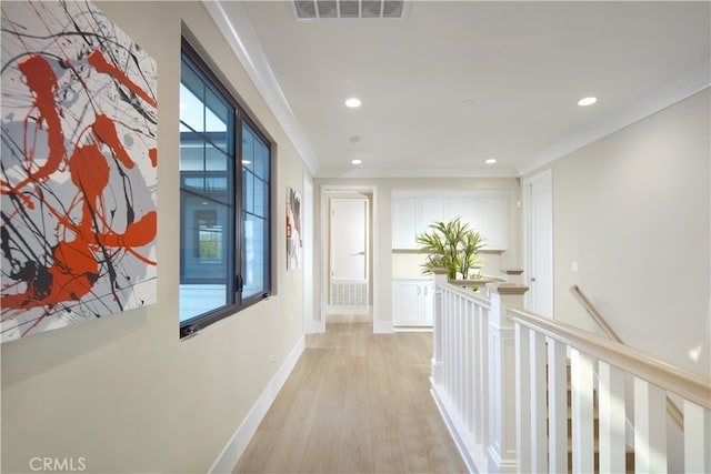 hall featuring light hardwood / wood-style flooring and ornamental molding