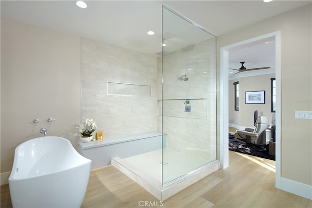 bathroom featuring separate shower and tub, ceiling fan, and hardwood / wood-style flooring