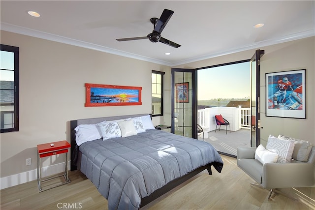 bedroom featuring ceiling fan, light hardwood / wood-style flooring, and multiple windows