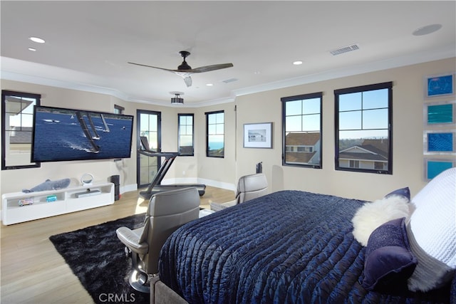 bedroom with wood-type flooring, crown molding, and ceiling fan