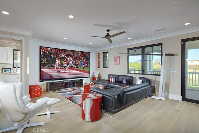 living room with a healthy amount of sunlight, crown molding, ceiling fan, and light hardwood / wood-style flooring