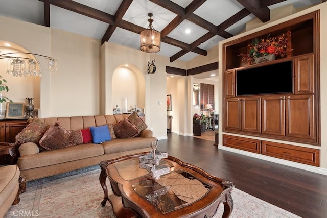 living room featuring coffered ceiling, an inviting chandelier, hardwood / wood-style floors, and beam ceiling